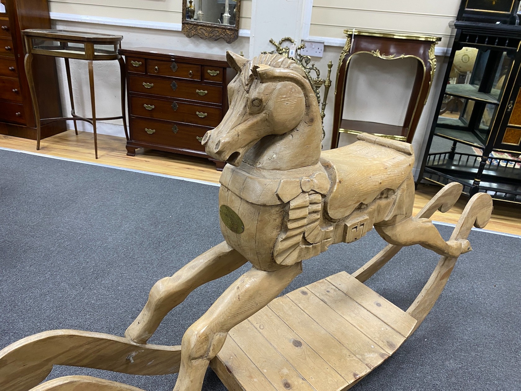 A carved pine rocking horse, height 93cm.